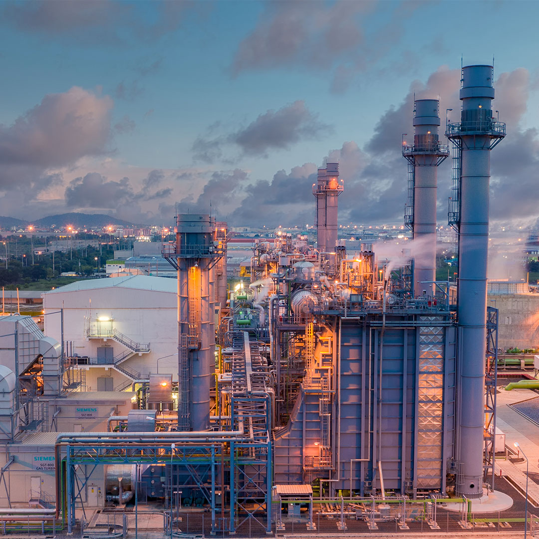 An industrial power plant at dusk showcasing Marsulex Environmental Technologies' AS WFGD system that converts SO2 into eco-friendly fertilizer, enhancing sustainability.