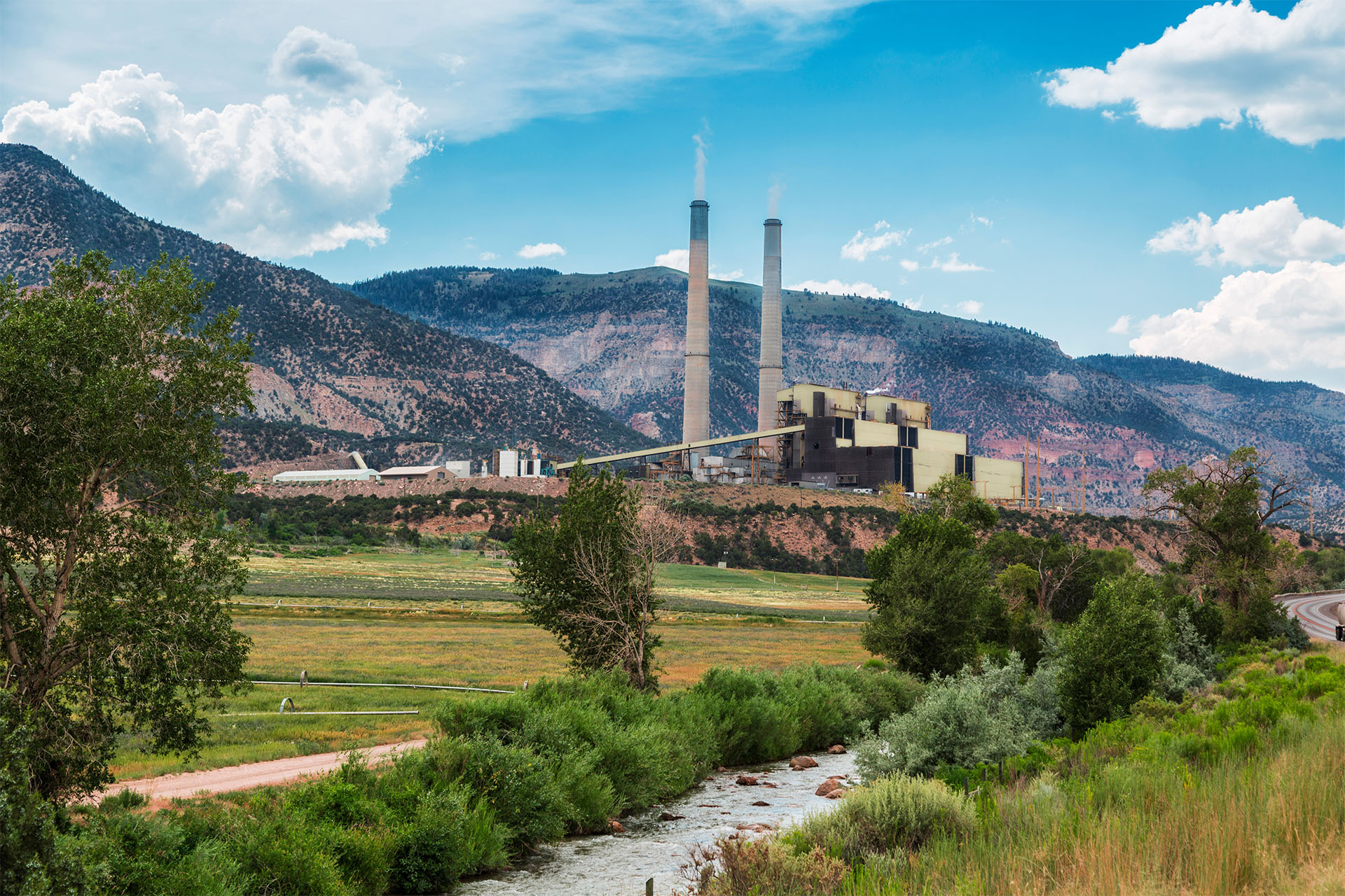 Power station nestled in a natural landscape, representing over thirty years of WFGD technology success at PacifiCorp's Hunter and Huntington stations.